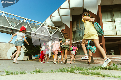 Image of Happy kids playing at city\'s street in sunny summer\'s day