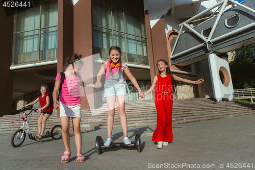 Image of Happy kids playing at city\'s street in sunny summer\'s day