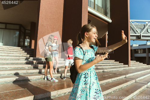 Image of Happy kids playing at city\'s street in sunny summer\'s day