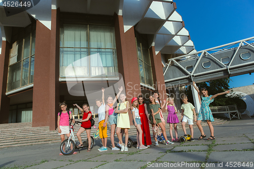 Image of Happy kids playing at city\'s street in sunny summer\'s day