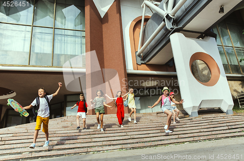 Image of Happy kids playing at city\'s street in sunny summer\'s day