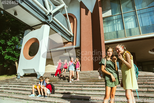 Image of Happy kids playing at city\'s street in sunny summer\'s day