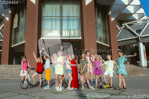 Image of Happy kids playing at city\'s street in sunny summer\'s day