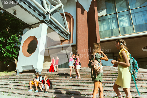 Image of Happy kids playing at city\'s street in sunny summer\'s day