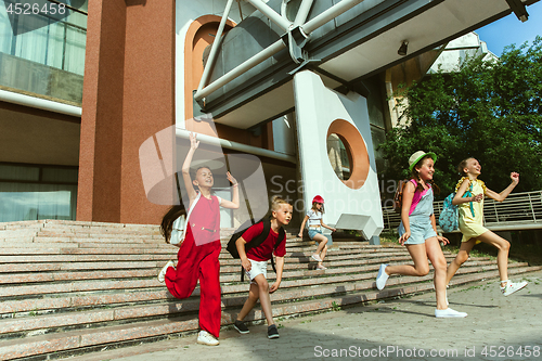 Image of Happy kids playing at city\'s street in sunny summer\'s day