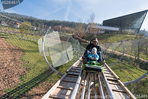 Image of father and son enjoys driving on alpine coaster