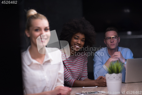 Image of Multiethnic startup business team in night office