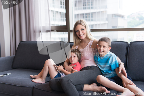 Image of young mother spending time with kids