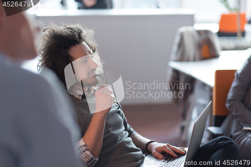 Image of businessman working using a laptop in startup office