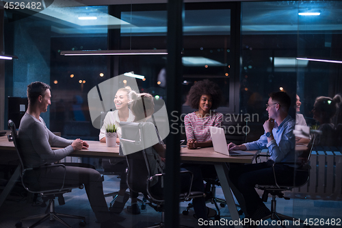 Image of Multiethnic startup business team in night office