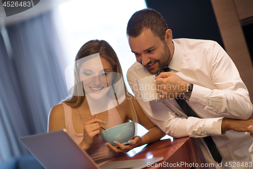 Image of A young couple is preparing for a job and using a laptop