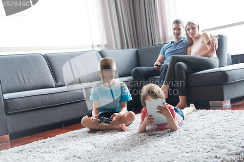 Image of couple spending time with kids