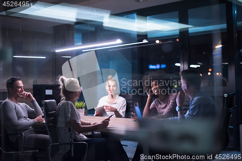 Image of Multiethnic startup business team in night office