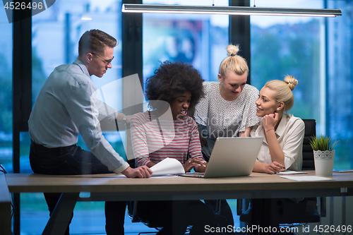 Image of Multiethnic startup business team in night office