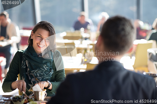 Image of Closeup shot of young woman and man having meal.