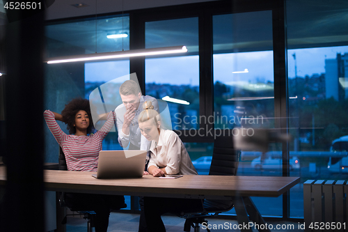 Image of Multiethnic startup business team in night office