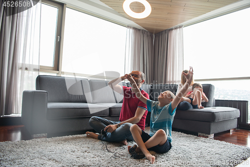 Image of Happy family playing a video game