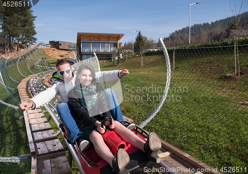 Image of couple enjoys driving on alpine coaster