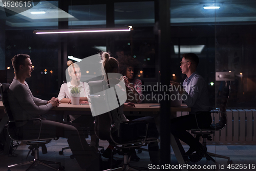 Image of Multiethnic startup business team in night office