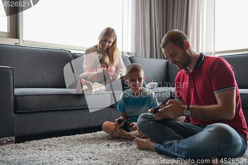 Image of Happy family playing a video game