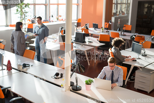 Image of Two Business People Working With laptop in office