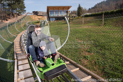 Image of father and son enjoys driving on alpine coaster