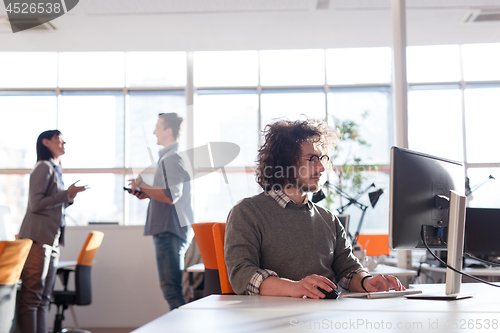 Image of businessman working using a computer in startup office