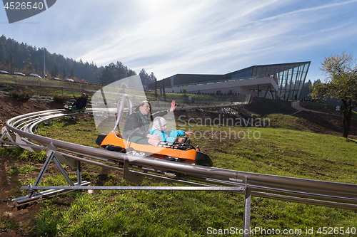 Image of mother and son enjoys driving on alpine coaster