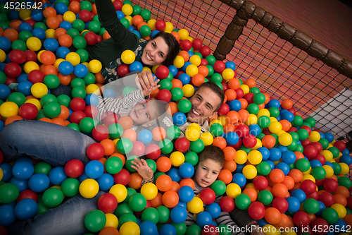 Image of young parents with kids in a children\'s playroom