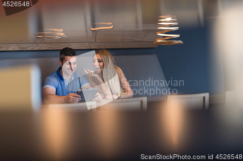 Image of couple using tablet at home