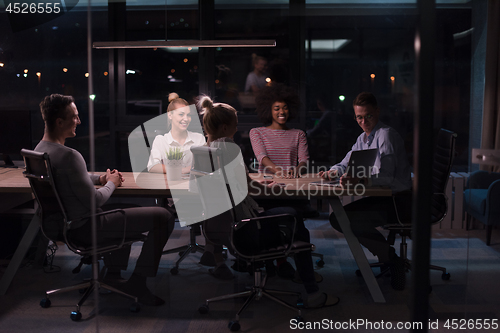 Image of Multiethnic startup business team in night office