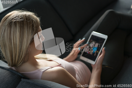 Image of woman using tablet in beautiful apartment