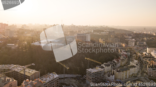 Image of Artistic Kiev School and Construction workers at work are at the top of the building on Vozdvizhenka in Kiev