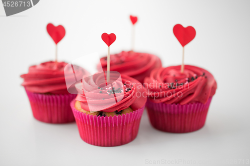 Image of close up of cupcakes with heart cocktail sticks