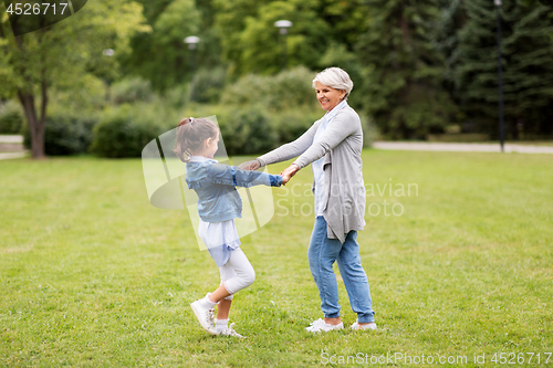 Image of grandmother and granddaughter playing at park