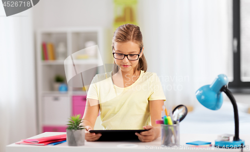 Image of student girl with tablet computer doing homework