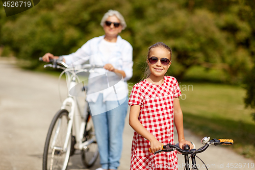 Image of grandmother and granddaughter with bicycles