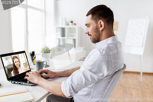 Image of businessman having video call on laptop at office