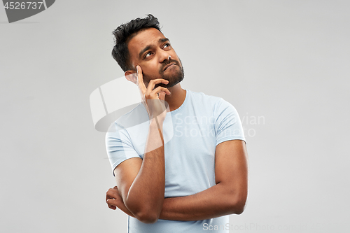 Image of indian man thinking and looking up