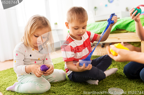 Image of children with modelling clay or slimes at home