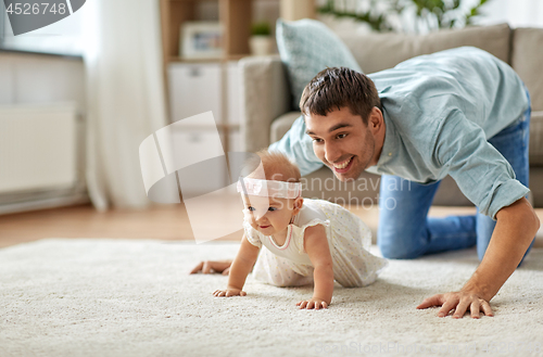 Image of happy little baby girl with father at home