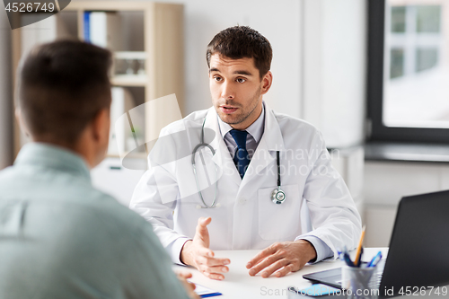 Image of doctor with laptop and male patient at hospital