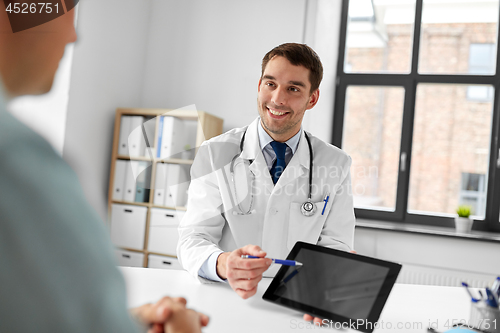 Image of doctor with tablet computer and patient at clinic