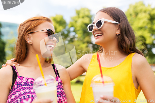 Image of teenage girls with milk shakes at summer park