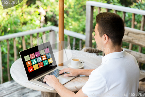 Image of man with smart home icons on laptop computer