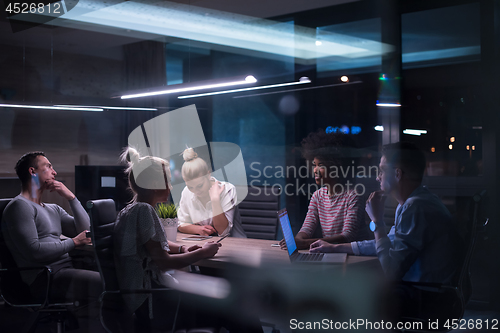 Image of Multiethnic startup business team in night office