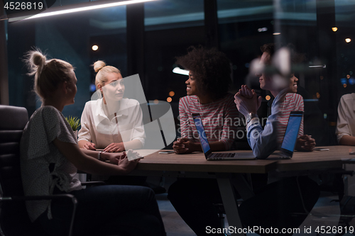 Image of Multiethnic startup business team in night office