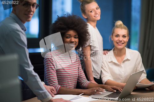 Image of Multiethnic startup business team in night office