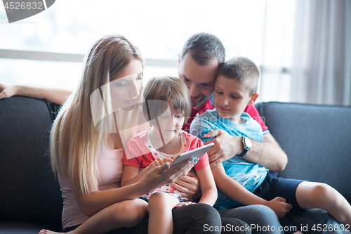 Image of happy young couple spending time with kids