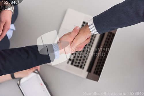Image of cloasing the deal in modern office interior top view